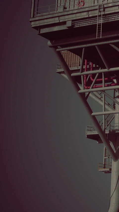 Construction structure stands tall against a dark sky at an industrial site Stock Footage 335690675