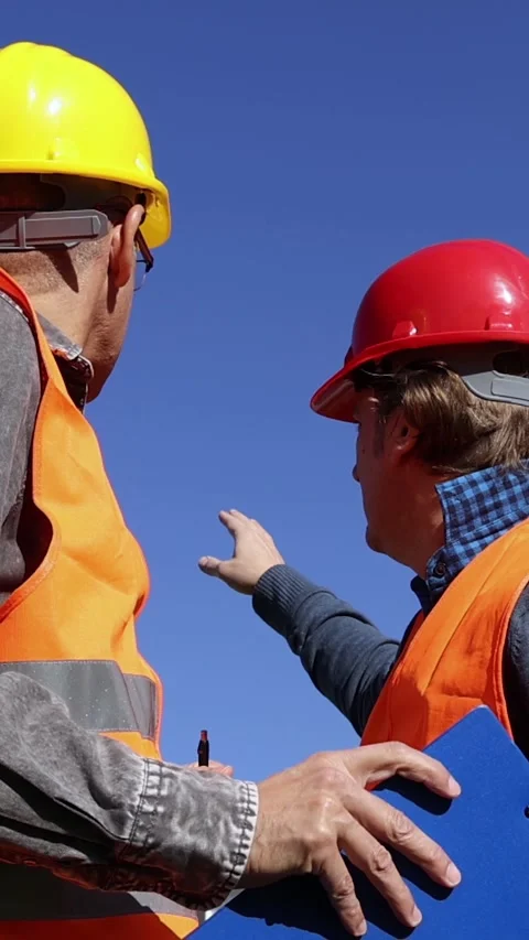 Construction Supervisor and Engineer Reviewing Blueprint at Construction Site Stock Footage 313036959
