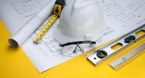 Construction Supervisor Building tools with Blueprints Stock Photos
