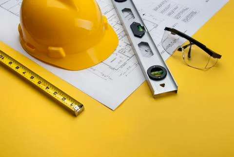 Construction Supervisor Building tools with Blueprints Stock Photos