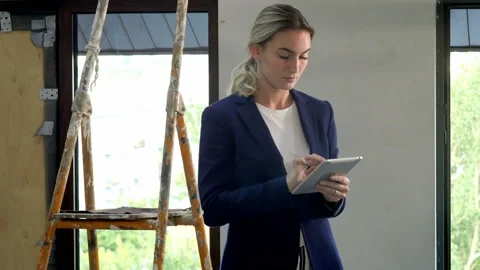 Construction supervisor checks the interior of a new warehouse being constructed 動画素材 90735703