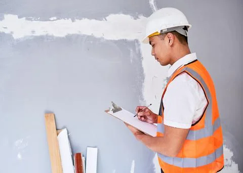 A construction supervisor checks renovation project with checklist on clipboard Stock Photos