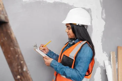 A construction supervisor checks renovation project with checklist on clipboard Stock Photos