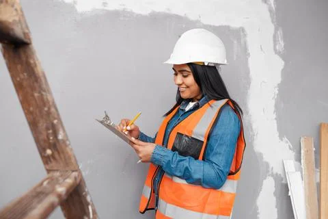 A construction supervisor checks renovation project with checklist on clipboard Stock Photos