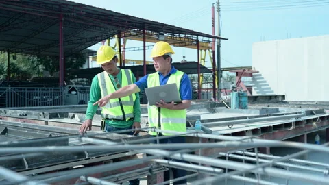 Construction supervisor monitors progress and supervises Stock Footage 255350341