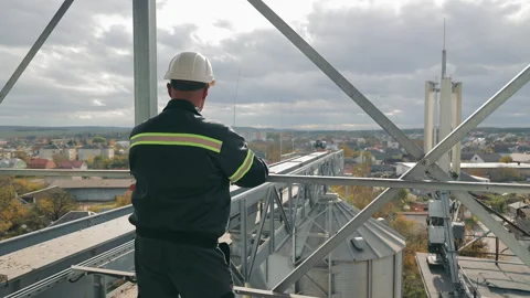 Construction Supervisor Overseeing Site, A construction supervisor inspects a Stock Footage 258916175
