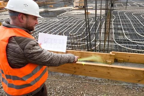 Construction supervisor with plan marking the site Stock Photos
