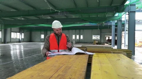 Construction supervisor with plan on site Stock Footage 74677020