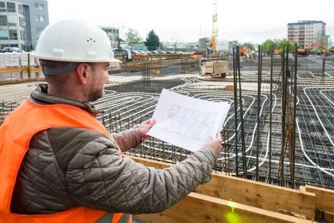 Construction supervisor with plan on site Stock Photos
