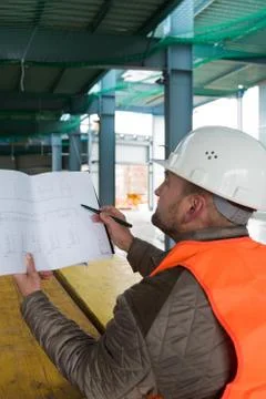 Construction supervisor with plan on site Stock Photos