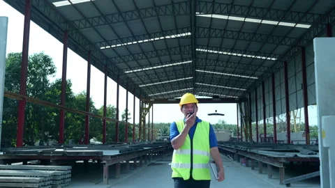 Construction supervisor walks to inspect work, Stock Footage 255351944