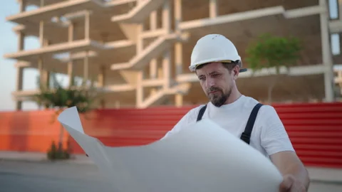 Construction supervisor wear white safety helmet and work overalls reviewin.. Stock Footage 341333682