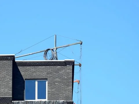 Construction suspended cradle for robots with a facade of a high-rise multi-s Stock Photos
