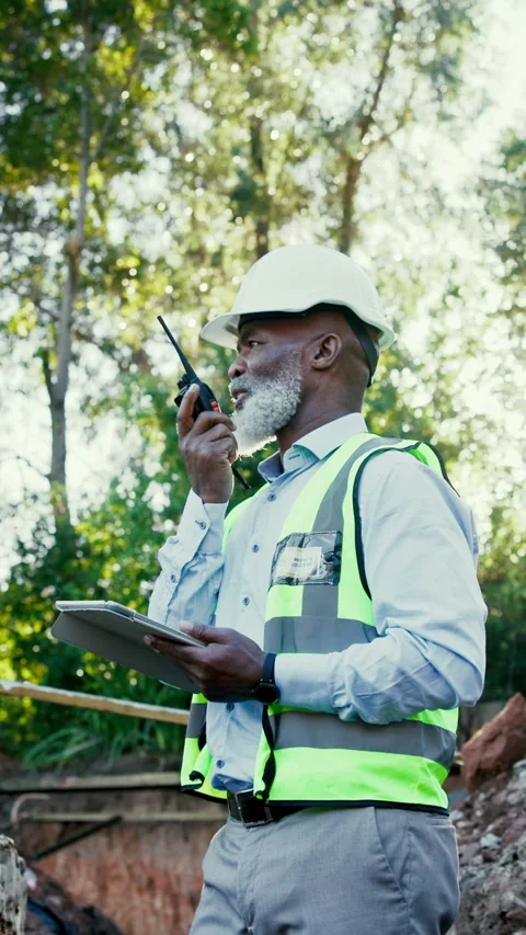 Construction, tablet or black man with radio, site check or safety inspection in Stock Footage 340458066