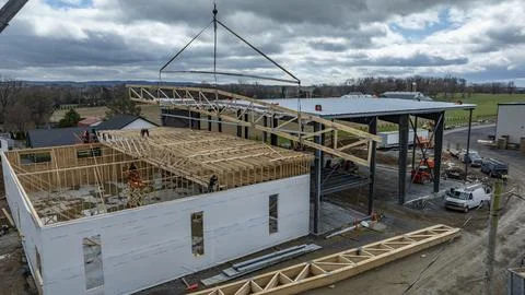 Construction Team Builds New Structure With Wooden Beams in Open Area Near .. Stock Photos