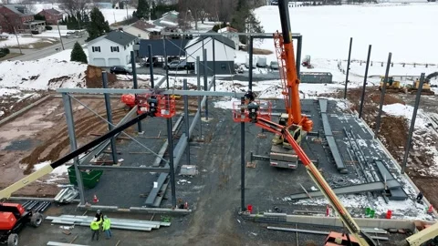 Construction Team Builds a Structure in a Snowy Area With Cranes and Worker.. Video stock 337642375