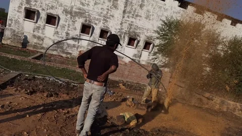 Construction Team cleaning the borewell in the rural village Stock Footage 199677421