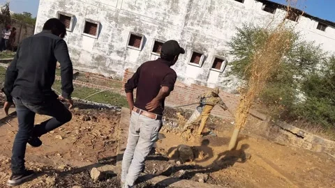 Construction Team cleaning the borewell in the rural village Stock Footage 199677466