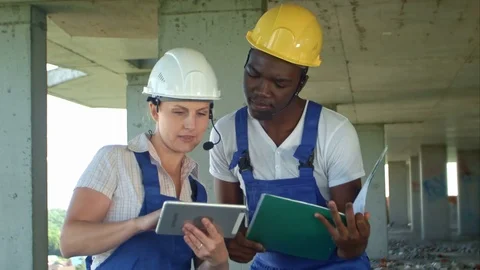 Construction team consult and consider plans for the construction 스톡 동영상 82803003