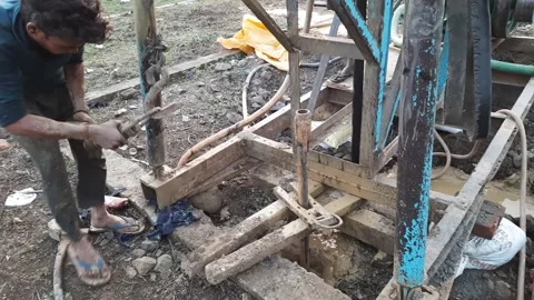 Construction Team drilling for borewell in the rural village Stock Footage 199677693