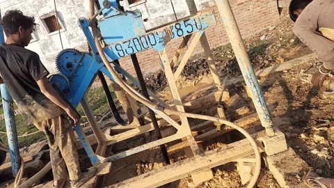 Construction Team drilling for borewell in the rural village Stock Footage 199677949