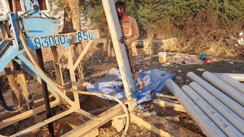 Construction Team drilling for borewell in the rural village Stock Footage 199679657