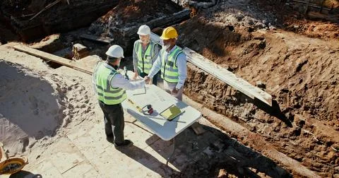 Construction team, handshake and engineer people in partnership outdoor with Fotos Stock