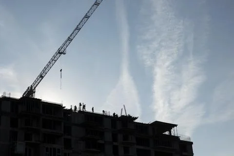 Construction team working together to finish rising concrete tower Stock Photos