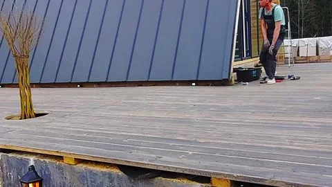 Construction team works on deck installation at a building site during daylight Stock Footage 337530277