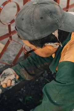 Construction technicians with hearing aid working with cement paving, mix wit Stock Photos