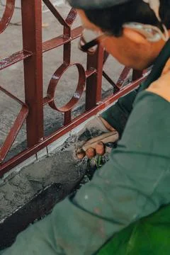 Construction technicians with hearing aid working with cement paving, mix wit Stock Photos