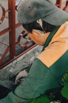 Construction technicians with hearing aid working with cement paving, mix wit Stock Photos