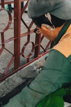 Construction technicians with hearing aid working with cement paving, mix wit Stock Photos