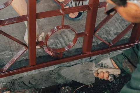 Construction technicians with hearing aid working with cement paving, mix wit Stock Photos