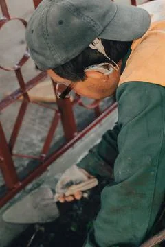 Construction technicians with hearing aid working with cement paving, mix wit Stock Photos