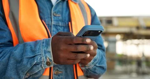 Construction, text message or hands outdoor with phone, task instruction or Stock Photos