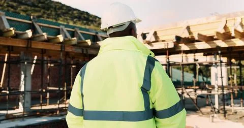 Construction, thinking and back of man for site inspection, planning and Stock Photos