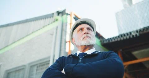 Construction, thinking or man with arms crossed, progress reflection or Stock Photos