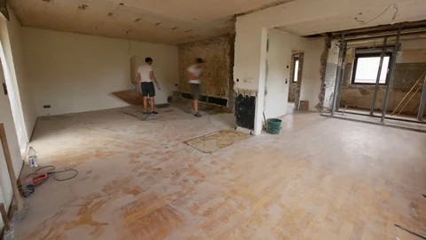 Construction time lapse - two young worker men removing laminate from the floor Stock Footage 91153462