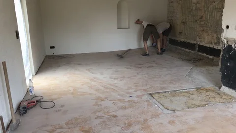 Construction time lapse - two young worker men removing laminate from the floor Stock Footage 91187524