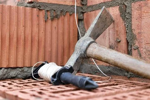 Construction tool for laying bricks and blocks. Bricklayer's tools - hammer,  Photos