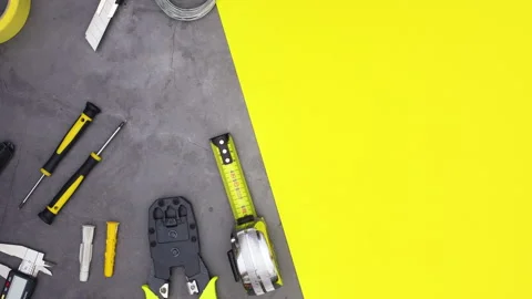 Construction tools and building plans appear on the table. Stop motion Stock Footage 136919079