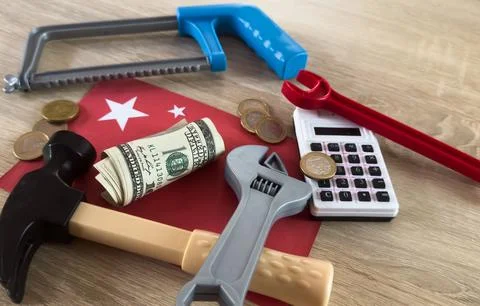 Construction tools and currency arranged on a table surface in a practical .. Stock Photos