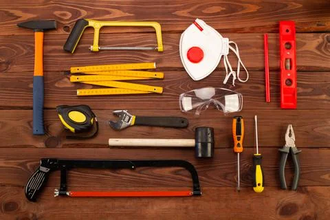 Construction tools and equipment on beautiful brown wood planks background Stock Photos