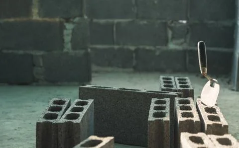 Construction tools and industrial bricks on construction site. Construction c Stock Photos