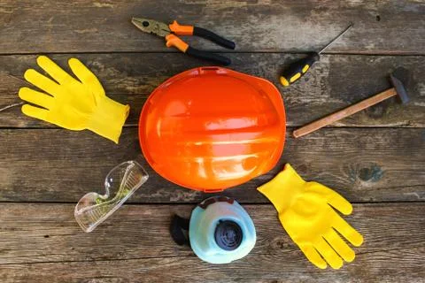 Construction tools and means of protection on an old wooden background. Top v Stock Photos