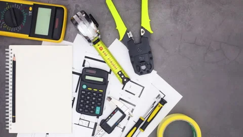 Construction tools and plans moving around open notebook. Stop motion Stock Footage 136914548