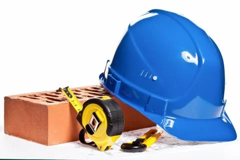 Construction tools, hardhat, brick and blueprint Stock Photos