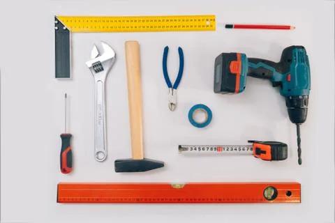 Construction tools on a light background. The concept of using tools to make  Stock Photos
