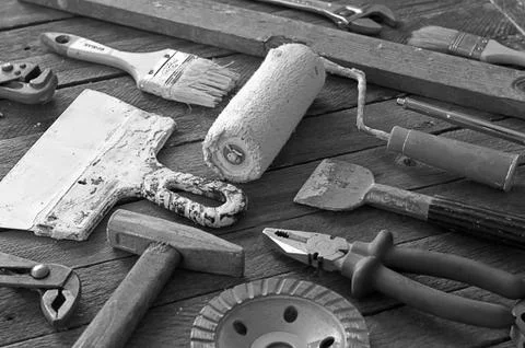 Construction tools lying on a wooden table Stock Photos